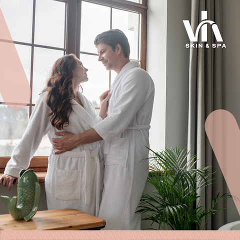 Happy couple in spa robes enjoying a relaxing moment by the window at an affordable couples spa in Durban – Vhi Skin & Spa.